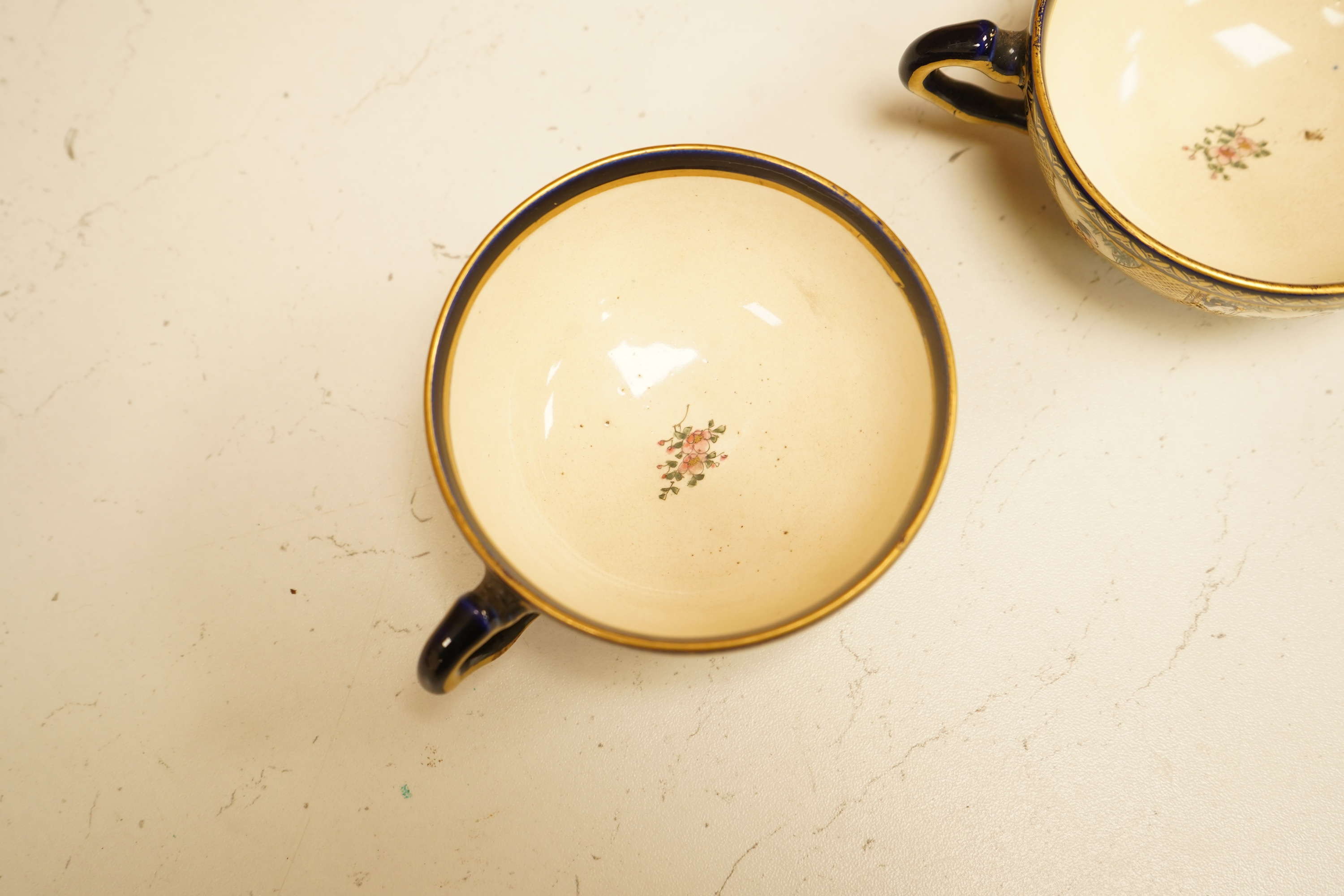 A set of six Japanese Satsuma pottery teacups and saucers, and two further saucers
